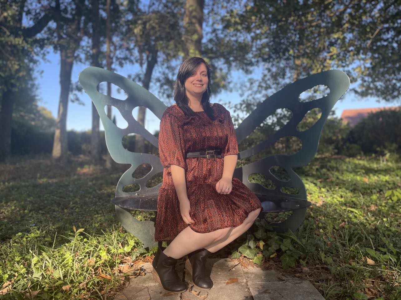 Krystine Rench sitting on butterfly bench