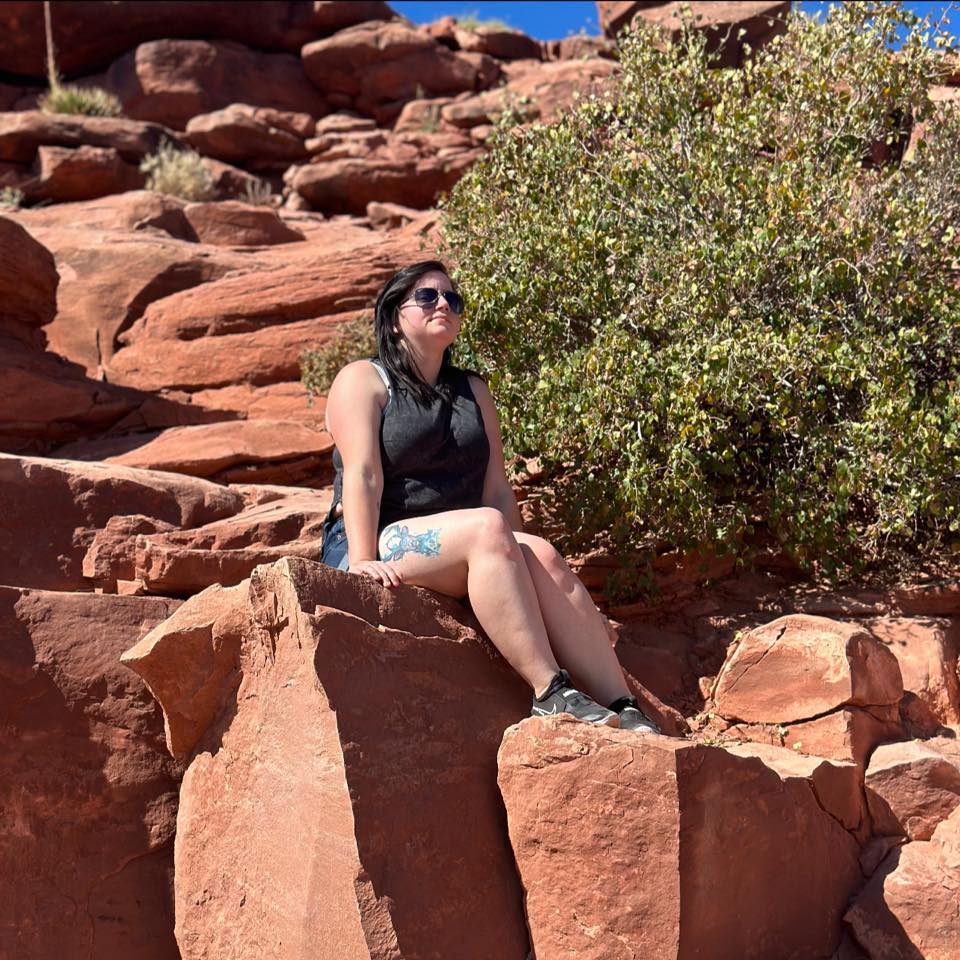 Krystine Rench sitting at the grand canyon